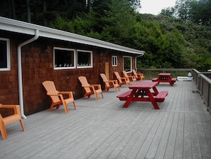 Large 17x70 deck with BBQ, picnic tables and Adirondack chairs.