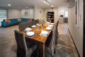 The kitchen, dining and lounge area. Sliding doors lead out to the back yard behind the dining area.