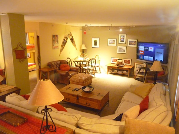 Mid floor main living room with big couch and  large screen TV