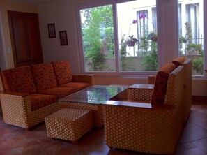 Bright, comfortable sitting area with huge glass picture window