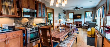 Dining room and living room with a fully equipped kitchen and living area. 
