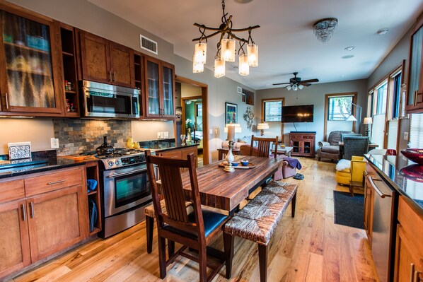 Dining room and living room with a fully equipped kitchen and living area. 
