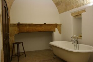 Stunning stone ceiling bathroom and claw-foot bath