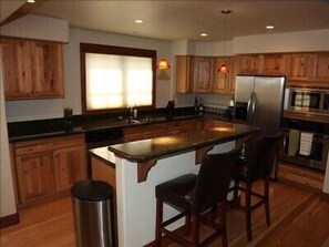Gourmet kitchen with stainless steel appliances and granite countertops.