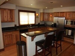 Gourmet kitchen with stainless steel appliances and granite countertops.