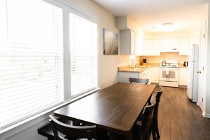 (Sample Photo) Dining room table with seating for 6 and fully equipped kitchen.