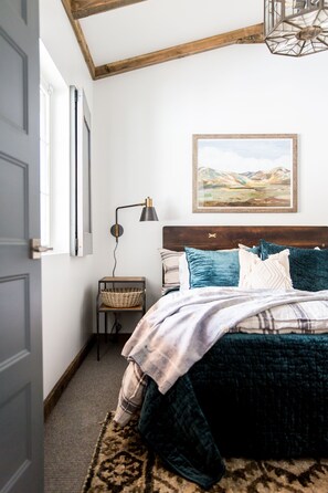 Master bedroom on main floor with queen bed, tv , connecting to main bathroom