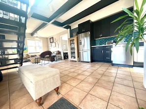 Overview of kitchen / living room space from the front door .