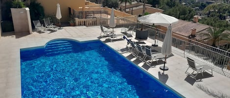 The pool enjoys great mountain views, sun loungers and parasols.