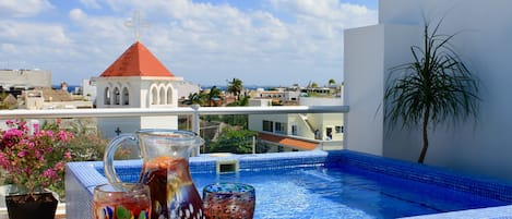 Enjoy a sangria while lounging in your private rooftop pool with ocean view