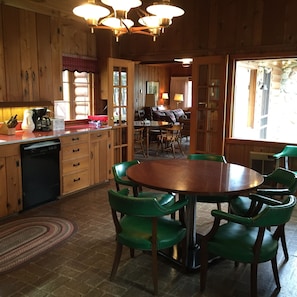 Fully equipped eat-in kitchen with river rock fireplace