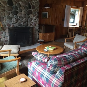 Cozy living room with river rock fireplace