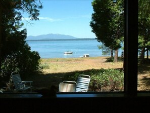View of the lake from the living room, showing buoy and small dock