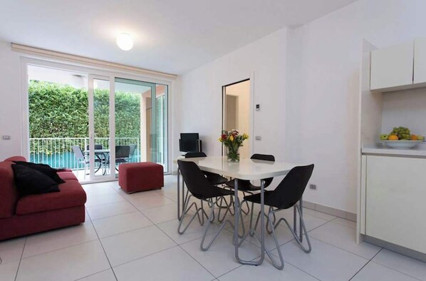 Living and dining area with doors to terrace