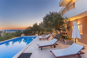 Private pool with sun loungers and swing