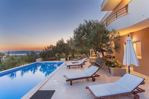 Private pool with sun loungers and swing