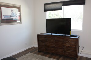 49" flat screen with chest of drawers.