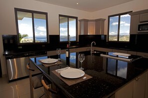 Beautiful ocean view kitchen with top of the line appliances and marble counters