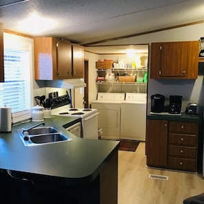 Large kitchen with adjacent laundry facilities