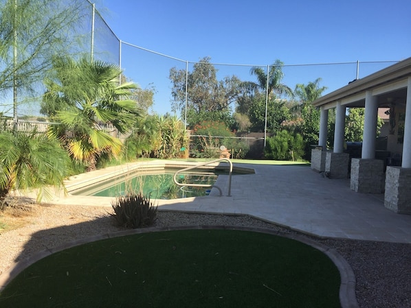 Relax  in the backyard artificial grass and enjoy the swimming or putting. 