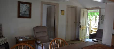 Living area, closed door lead to another bathroom, with stand up shower