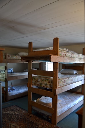 Room with 4 sets of 3 tier bunk beds...