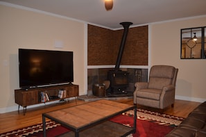 Large screen 4K smart TV and wood stove in Great room.