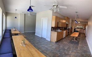 Upstairs kitchen: dining space, large fridge, stove, oven, 2 sinks & dishwashers