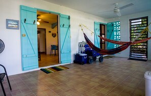 The Surf House patio area with two hammocks and beach gear!