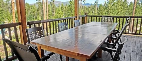 Covered deck and outdoor dining area with views