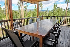 Covered deck and outdoor dining area with views