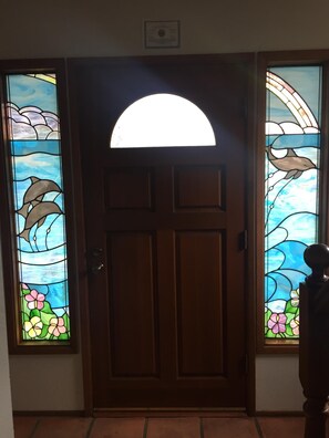 Front door w/ beautiful stained glass windows.