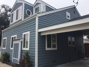 Side view of stand alone townhome with carport for parking.