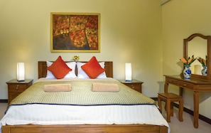 En-suite Bedroom with king size bed, air conditioning and large overhead fan 