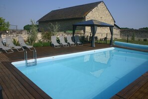 Enclosed swimming pool with pergola