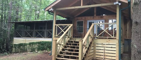 Back of cabin facing lake, with screen porch to the left and covered deck 