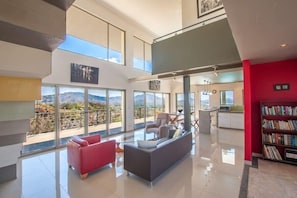 Living room with nice leather couch and flat screen tv plus ocean view