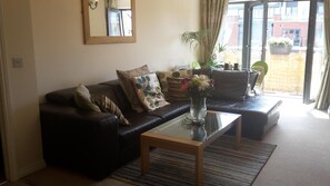 lounge dining area with sideboard/tv,coffee table and dining table and chai