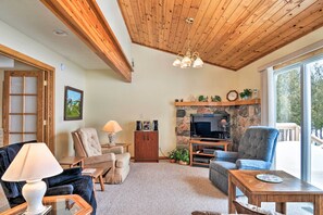 A slanted tongue & groove ceiling adds rustic charm to the living room.