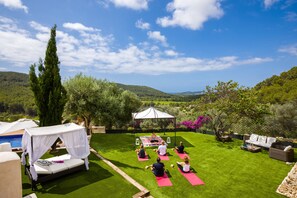 Yoga on lawn with stunning views. Yoga mats provided.