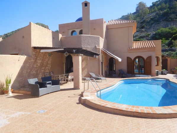 villa rear view. shaded area for eating. Tolda (awning) for 2 sun loungers.