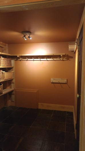 Mudroom with pegs for jackets and lots of storage.