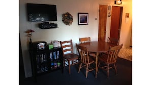 Living room and dining area with TV, VCR, DVD player and Radio