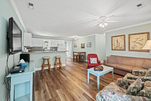 The living room is open to the kitchen & dining area.