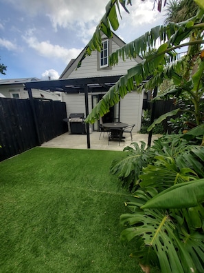 Private courtyard with covered seating area and BBQ