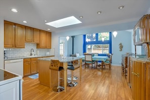 Remodeled kitchen with granite counter tops and island has bar seating for 3.