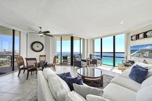 Floor-to-ceiling windows w/ shades that pull all the way back allow great views throughout the living room and kitchen