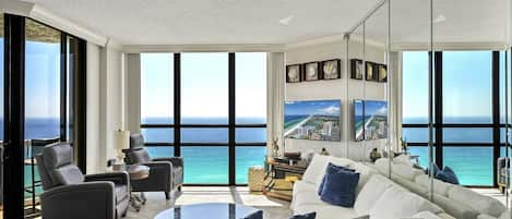 Floor-to-ceiling windows w/ shades that pull all the way back allow great views throughout the living room and kitchen