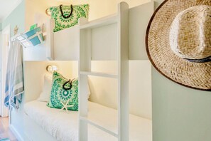 Cozy coastal bunkbeds (2 beds) tucked away in the hall for privacy—4 beds total