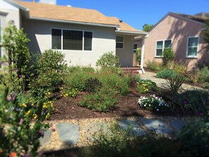 Front Yard with lush plants that provide a beautiful view outside  living room.